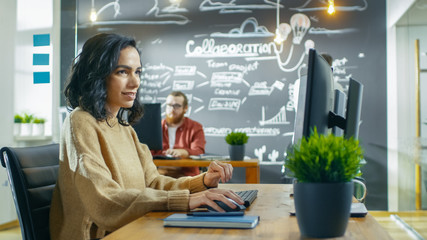 Wall Mural - beautiful woman mobile game application developer works on a personal computer, designing wireframe.