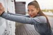 © Flamingo Images - Young Asian woman in sportswear stretching outdoors before a run