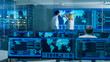 © Gorodenkoff - In the System Monitoring Room Two Senior Operators Work on a Big Interactive Map. Facility is Full of Screens Showing Technical Data.