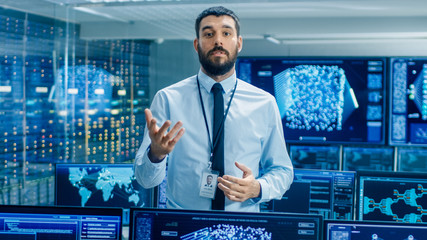 Leinwandbilder - In the World's Top Machine Learning Facility Scientist Excitedly Describes Project He Works on. Background Shows Screens with Working Neural Network/ Artificial Intelligence.