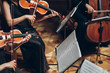 Elegant string quartet playing in luxury room at wedding reception in restaurant. group of people in black performing on violin and cello at theatre orchestra, music concept