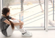 © New Africa - Lonely little girl near window indoors. Child autism
