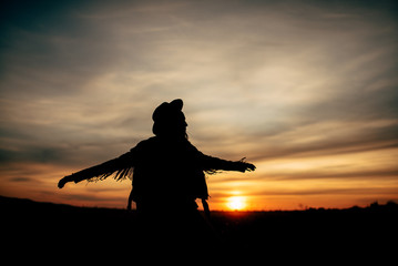 Wall Mural - Boho nomads girl in field at Sunset