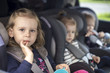 © ondrooo - cute small sisters in car seats in the car