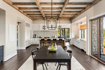 Wall Mural - Stunning dining room and kitchen in new luxury home.Wood beams and elegant pendant lights accent this beautiful open-plan dining room and kitchen