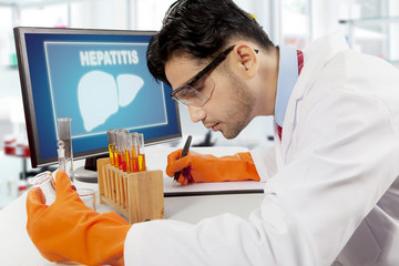 Canvas Print - Arabian scientist with liver symbol on computer