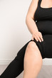 Overweight woman on light background, closeup of legs