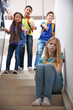 © Africa Studio - Bullied teenage girl on stairs at school