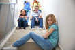 © Africa Studio - Bullied teenage girl on stairs at school