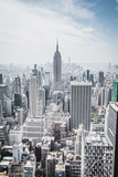 Fototapeta  - View from rockefeller center plattform over big apple new york city at a light cloudy day with blue sky, New York City, New York/ USA - August-21-2017