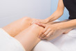 © Регина Аврамова - The specialist does massage of the knees to the client of the massage cabinet.