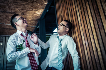 two businessman is drunk and laughing after drinking hard in restaurant to celebrate the success of work. concept of winner and business successful