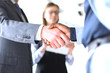 © ty - Business people shaking hands, finishing up a meeting.