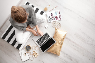 Female blogger with laptop indoors, top view