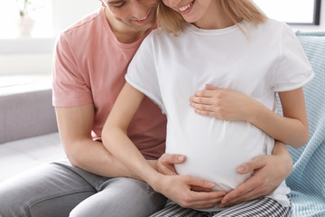 Poster - Young pregnant woman with her husband at home