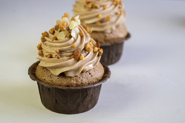 Chocolate cupcake with cream on dark background.