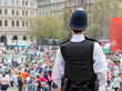 Rear view of Police Officer Watching Over Crowds in Trafalgar Square, London