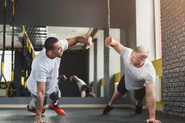 Canvas Print - Two happy men fitness workout together at gym