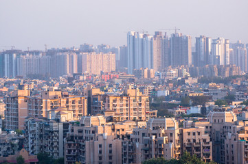 Wall Mural - Cityscape in Noida, gurgaon, jaipur, delhi, lucknow, mumbai, bangalore, hyderabad showing small houses sky scrapers and other infrastructure options