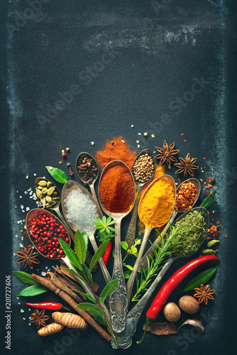Fotografia Various herbs and spices on dark background