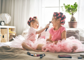 Wall Mural - sisters are doing hair and having fun