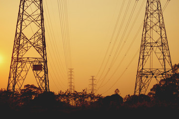 Wall Mural - high voltage poles on the orange sky concept of electric power