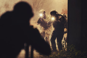 Wall Mural - rangers during the military operation with laser sights and lanterns.