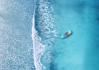 Wall Mural - wave and boat on the beach as a background. beautiful natural background at the summer time from air
