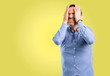 © Krakenimages.com - Handsome middle age man stressful keeping hand on head, tired and frustrated
