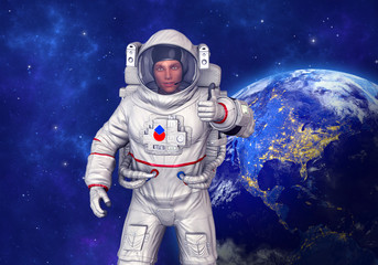 Wall Mural - astronaut showing thumbs up gesture, planet earth in background. elements of this image furnished by