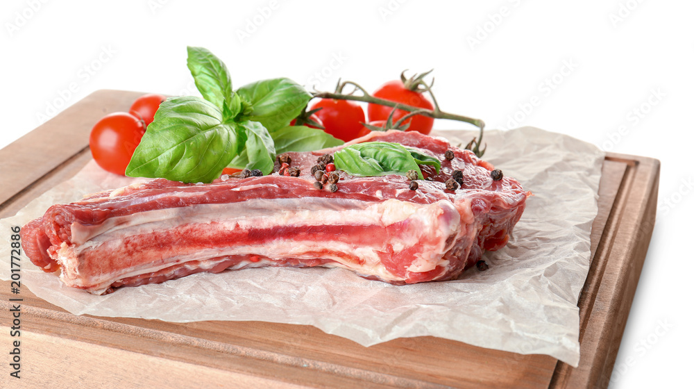 Wooden board with fresh raw pork rib isolated on white