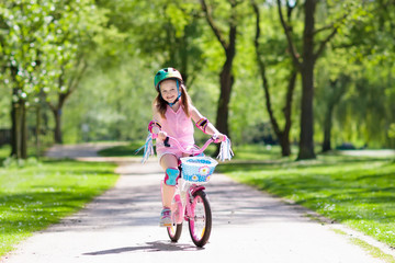 Wall Mural - Child on bike. Kids ride bicycle. Girl cycling.