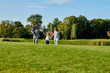 © DenisProduction.com - Reunion of american soldier with family. Walking and having fun together on the park grass.