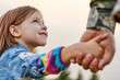 © DenisProduction.com - Close up portrait little girl looks at his military father. Lovely gaze of a daughter, holding hands.