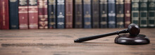 Judge Gavel And Law Books On A  Wooden Background.