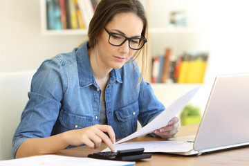 Wall Mural - Housewife doing accounting calculating expenses at home