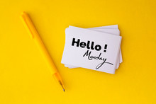 The Yellow Pen And Stacking Of  White Business Card With Hello Monday Message On Vibrant Yellow Background , Cheerful For Happy Working Time  Monday Concept