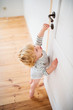 © Halfpoint - Toddler child in a dangerous situation at home.