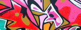 Fototapeta Młodzieżowe - Fragment of a beautiful graffiti pattern in pink and green with a black outline. Street art background image