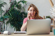 © Sergey - Portrait of florist woman talking on phone while sitting at table with computer