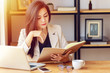 young Asian business woman working at workplace. beautiful Asian woman in casual suit working with reading book, prepare for meeting or interview in modern office. freelance and start up business in A