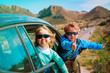 happy little boy and girl enjoy travel by car in mountains