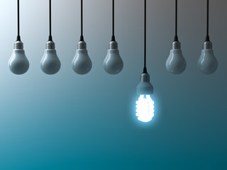 Fototapete - One hanging eco energy saving light bulb glowing and standing out from unlit light bulbs on dark green blue background , leadership and different creative idea concept. 3D rendering.