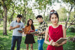 © Nattakorn - portrait asian young teen student standing in park for studying and education concept