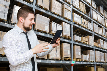 Poster - Manager with a tablet in warehouse