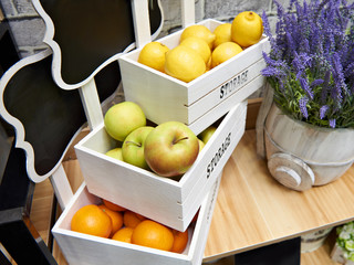 Wall Mural - Fruits apples, oranges and lemons in white boxes in store