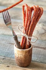 Poster - Smoked sausages on the wooden background