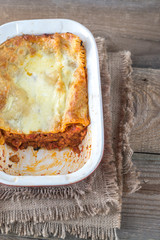 Wall Mural - Dish of lasagne on the wooden table