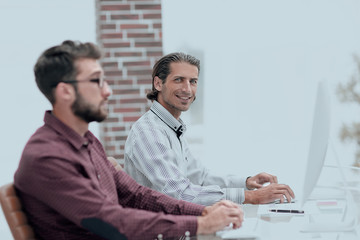 two employees work in the office