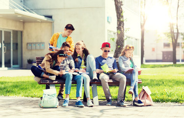 Poster - education, high school and people concept - group of happy teenage students with notebooks learning at campus yard